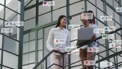 animation of notification bars over diverse female coworkers talking and using laptop on staircase