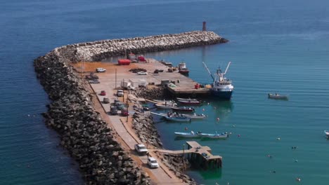 boat docked at cedros island harbor with turquoise waters and vibrant reflections in a scenic setting, drone orbit counterclockwise