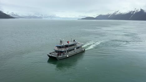 experience an unforgettable adventure in glacier bay, alaska as a tour boat navigates through pristine waters. breathtaking views of glaciers and mountains await in this remote paradise.