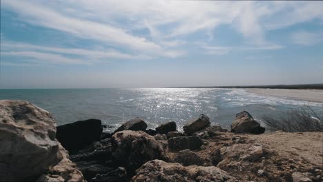 a view of the sea from behind some rocks