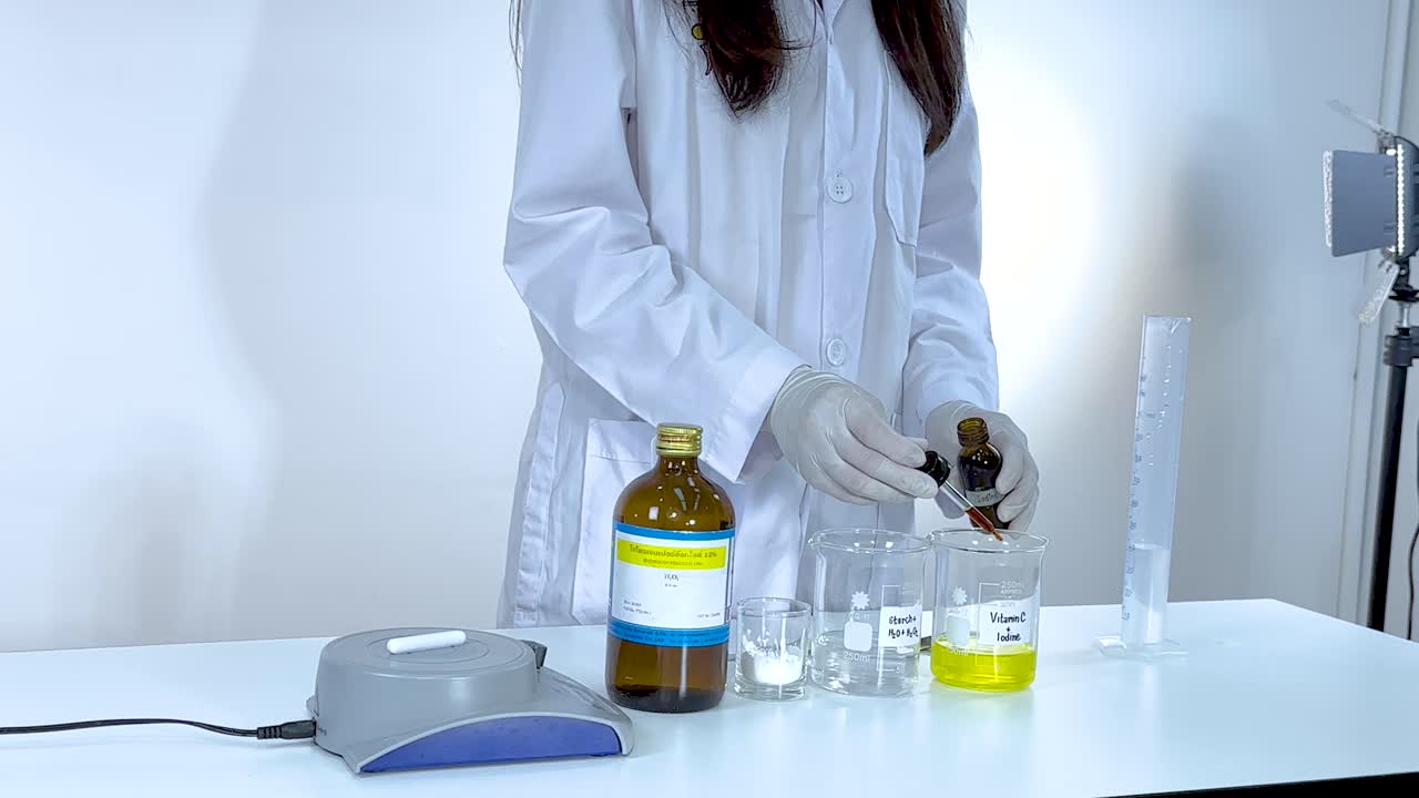 A scientist performs an iodine clock reaction in a lab setting, showcasing chemical changes with precise measurements and controlled conditions