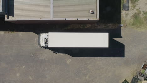 smooth aerial ascent above truck about to leave depot