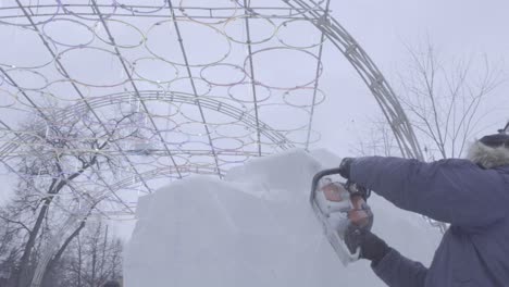 ice carving artist at winter festival