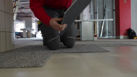 carpet tiler man laying and installing carpet rug floor wall to wall