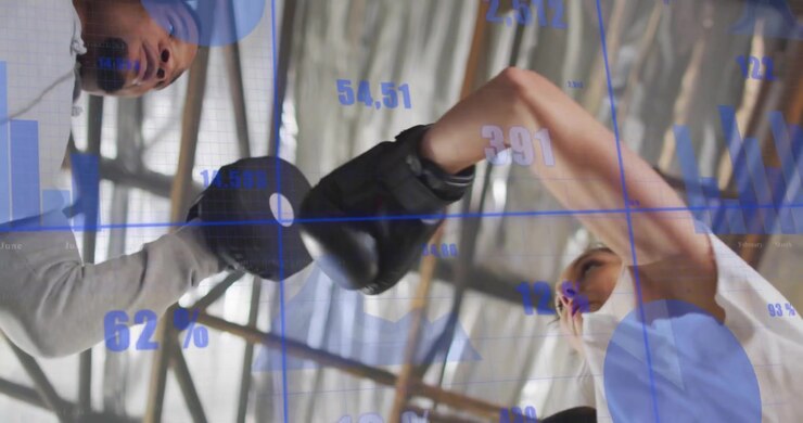 Trainer holding mitts initiating trainee throwing jabs and crosses with performance data tracking