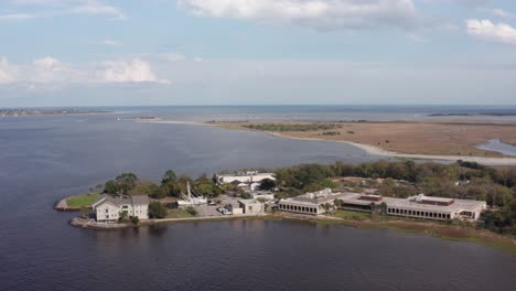 Close-up-panning-aerial-shot-of-Fort-Johnson-with-Fort-Sumter-in-the-distance-in-Charleston-Harbor,-South-Carolina