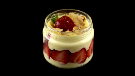 strawberry pudding jar turning on black backround