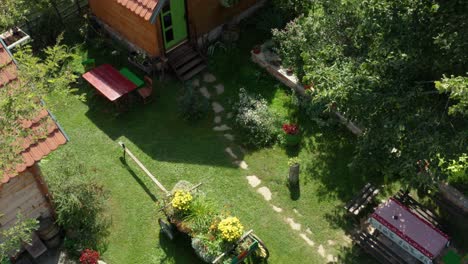 old vintage wooden house cottages on idyllic rural countryside garden - aerial drone shot