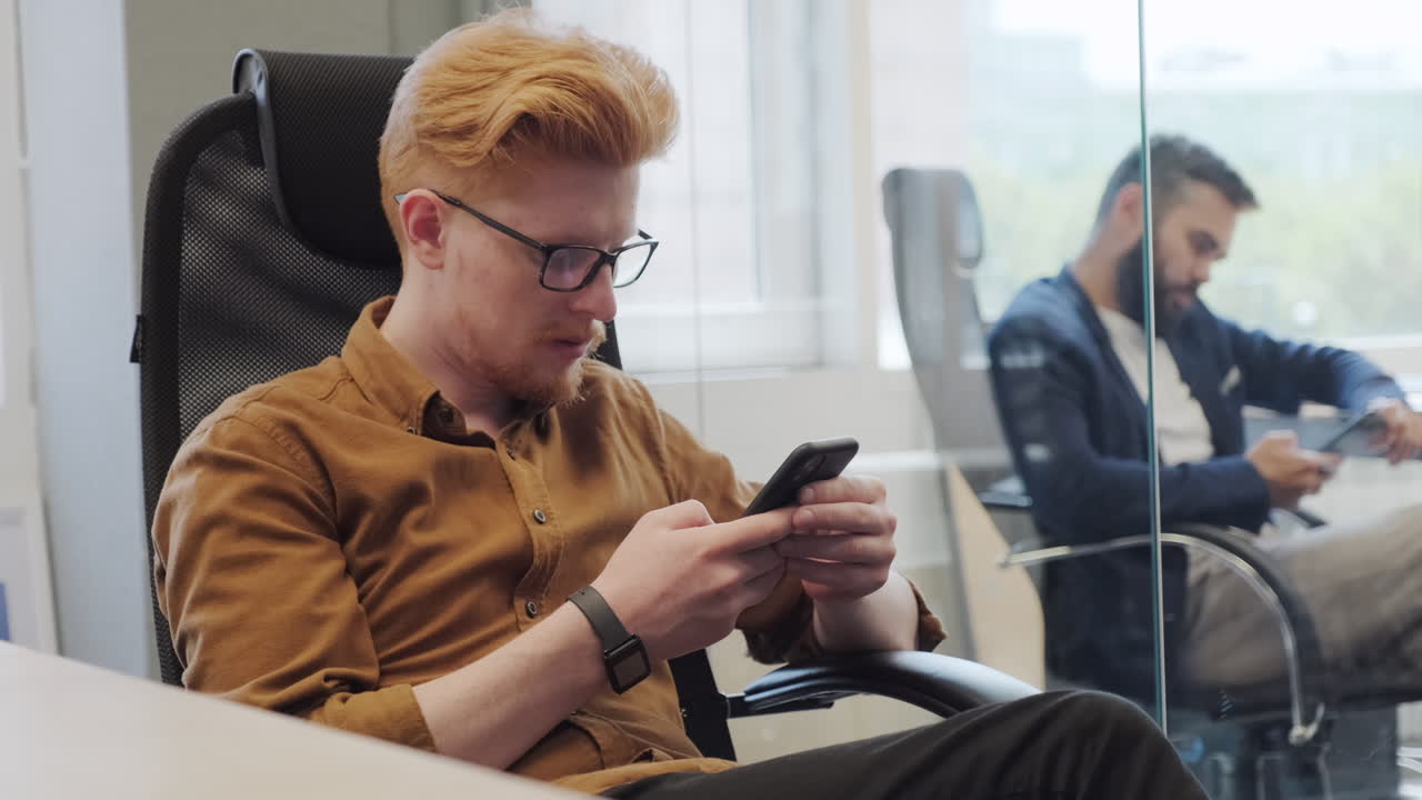 Businessmen Using Smartphones At Work