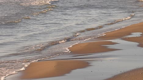 Gentle-waves-on-golden-sandy-shore,-suptropical-beach-slow-motion