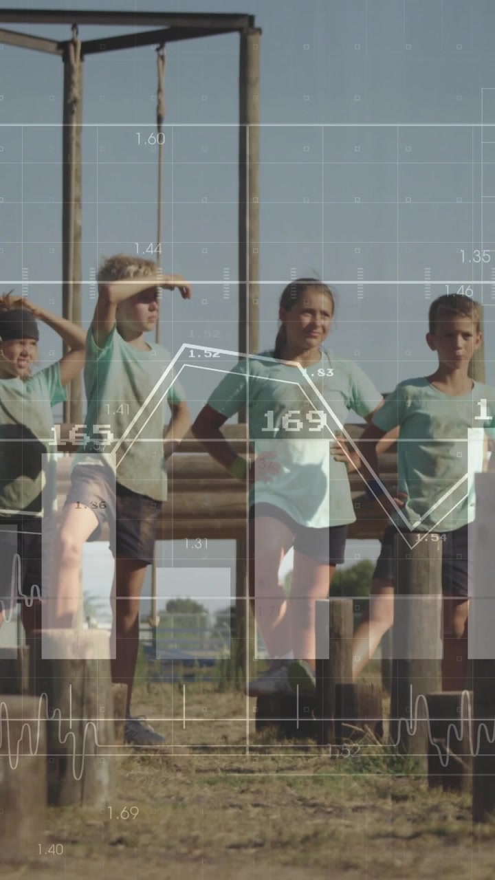 Vertical video: 4 kids balancing on posts, drill starting, data overlays over legs tracking fitness