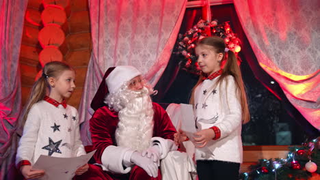lovely little girl indoors at christmas. cute children reading a letter to the santa. beautiful small girls spending time on xmas background at home
