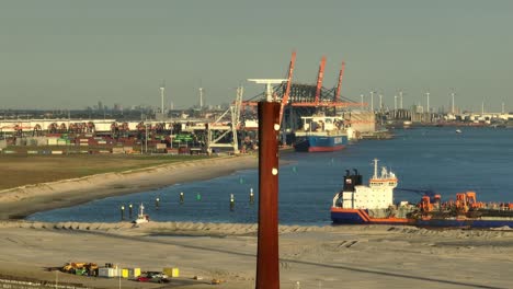 Marine-radar-tower-with-rotating-antenna-at-the-Rotterdam-port-used-for-electronic-navigation-system,-aerial-orbital-slow-motion