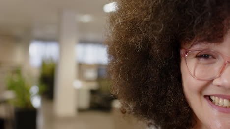 Portrait-of-smiling-casual-biracial-businesswoman-in-office,-slow-motion-with-copy-space