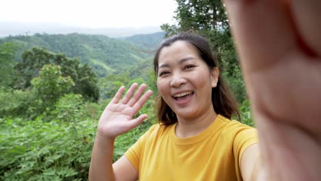 Positive-female-hipster-waving-a-hand-at-the-camera-during-video-chat-online