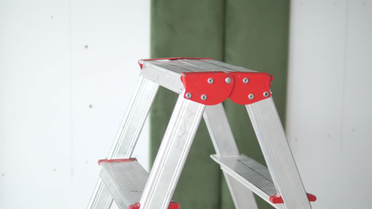 Aluminum Stepladder Against a Wall