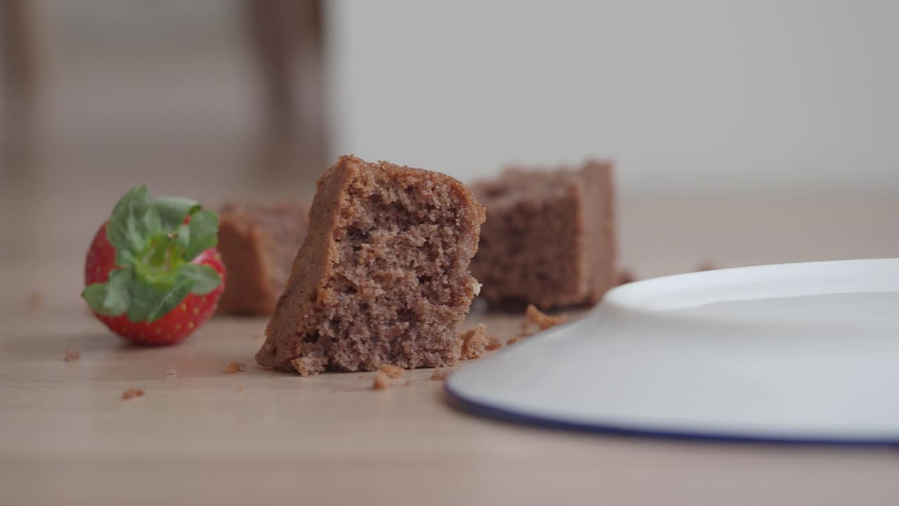 Pieces of chocolate cake with a strawberry and plate