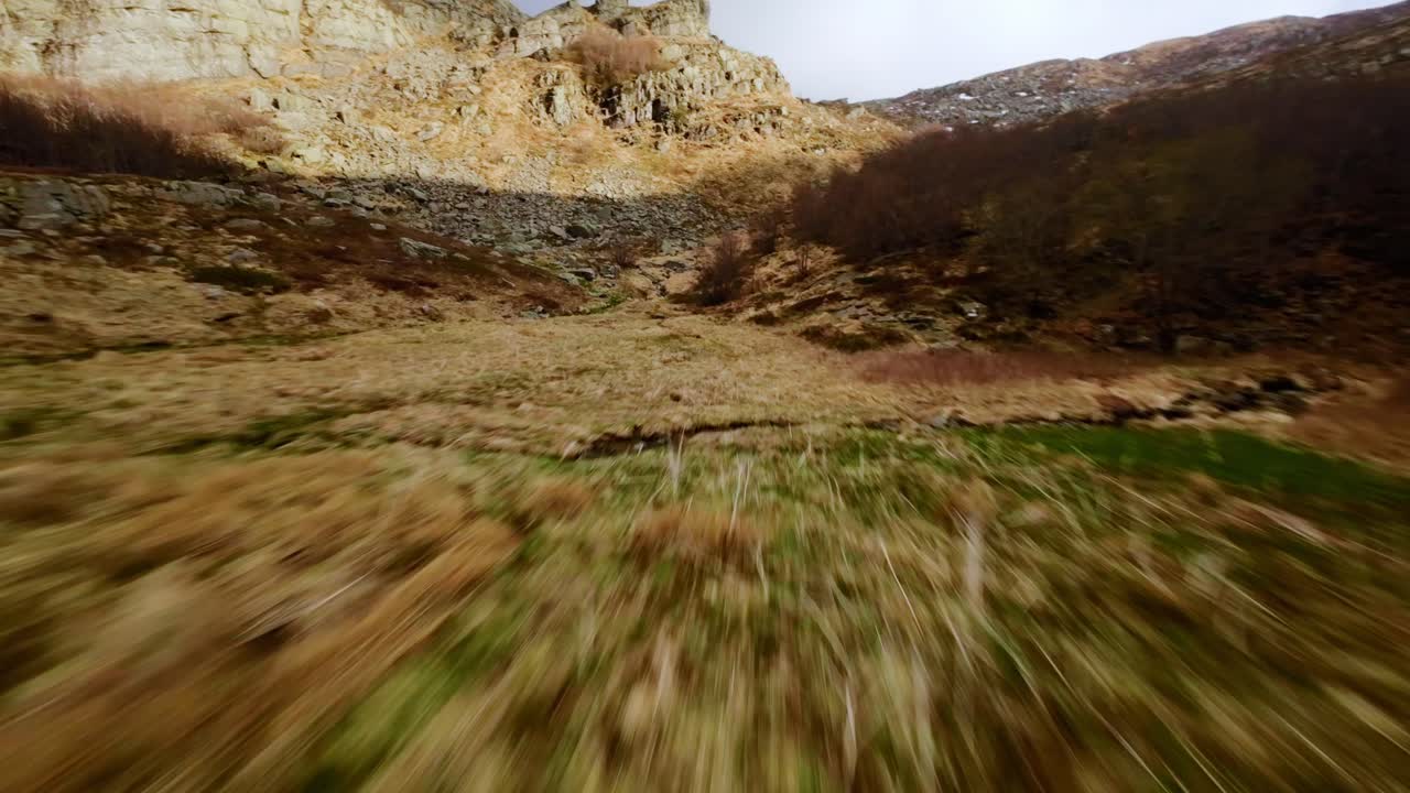 High-speed aerial dive through rocky Dolomite terrain, thrilling and energetic FPV flight