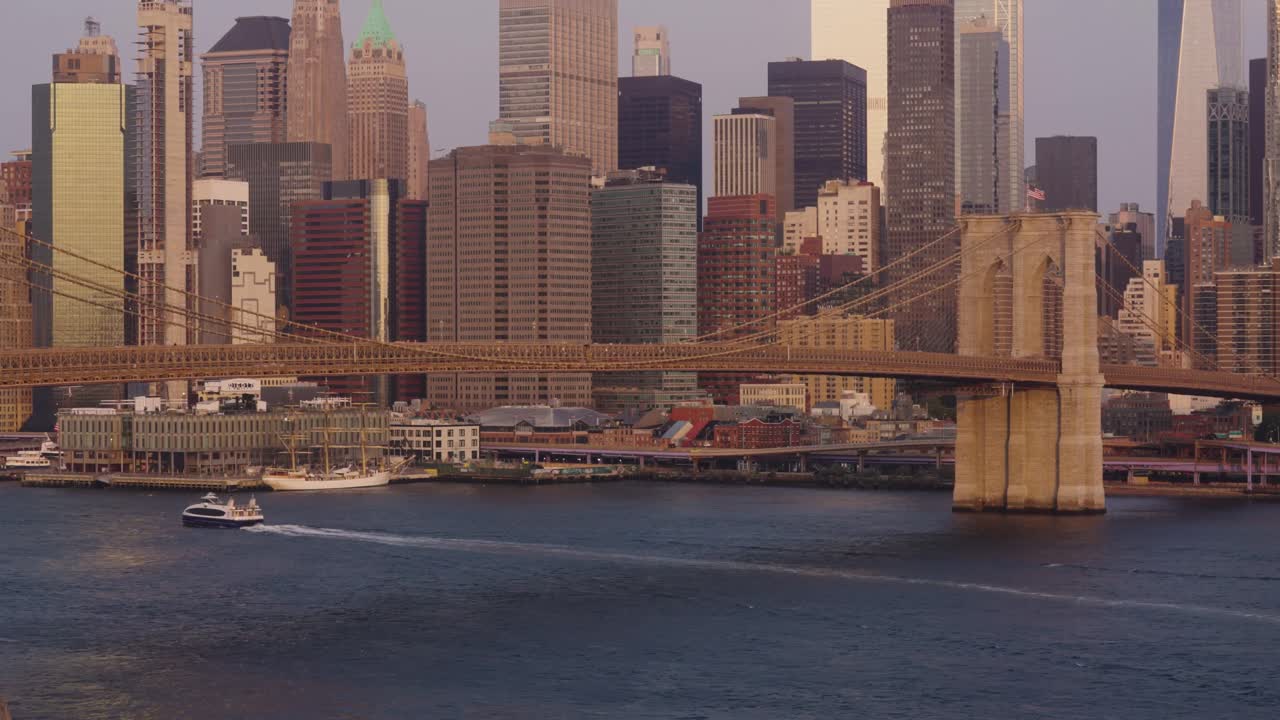 Panorama wide shot of famous Brookyln Bridge and Skyline of New York City during golden hour