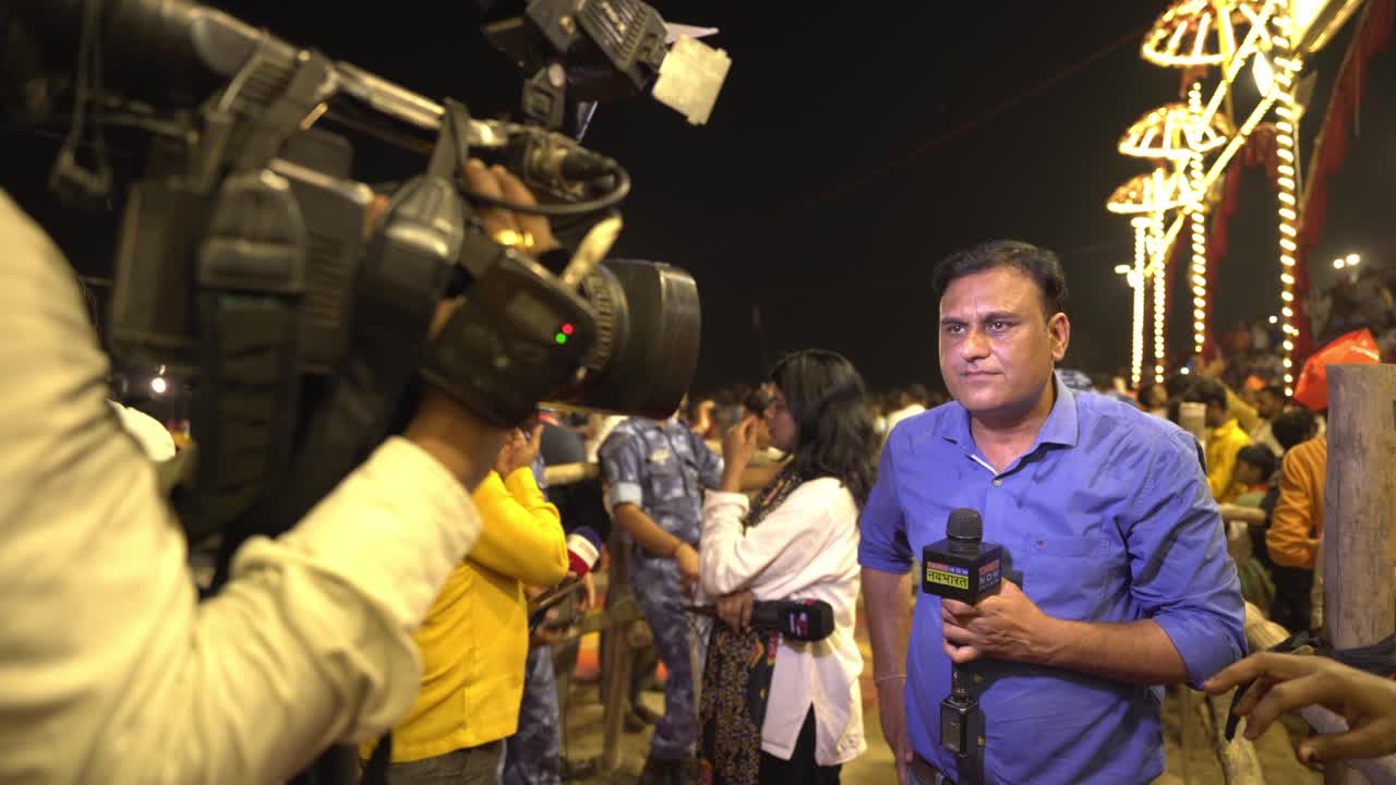 A news reporter broadcasting live at a public event.