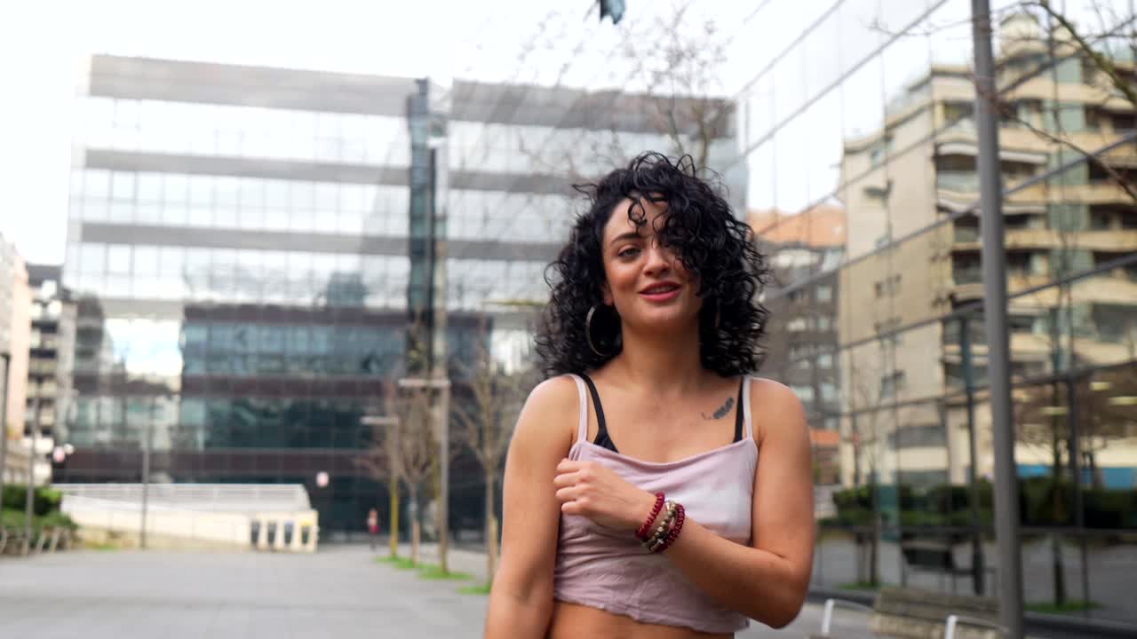 Woman with Curly Hair in Urban Setting