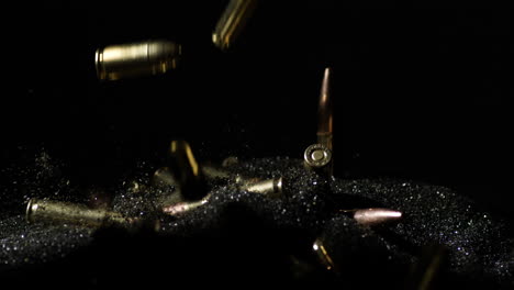 variety of gun bullets dropping over smokeless powder