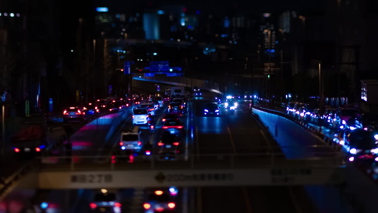 En natt-timelapse av et miniatyrkork i en bygate i Tokyo