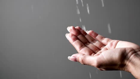 hand catching water droplets