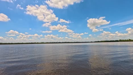 clouds drift over a calm summer lake