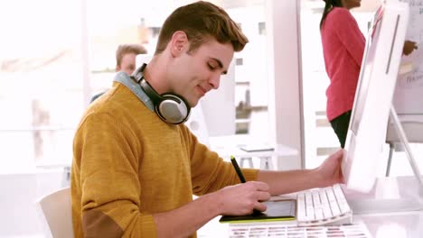 Graphic-designer-using-digitizer-at-his-desk