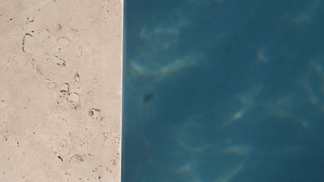 top down shot of pool with stone side frame and turqouise water