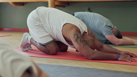 people doing child's pose in yoga class
