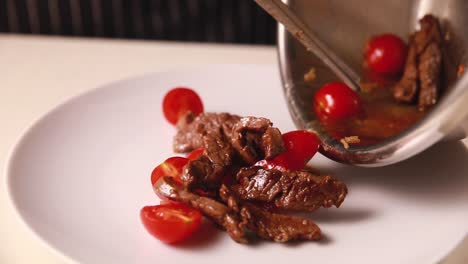 chef serving beef and tomato stir-fry