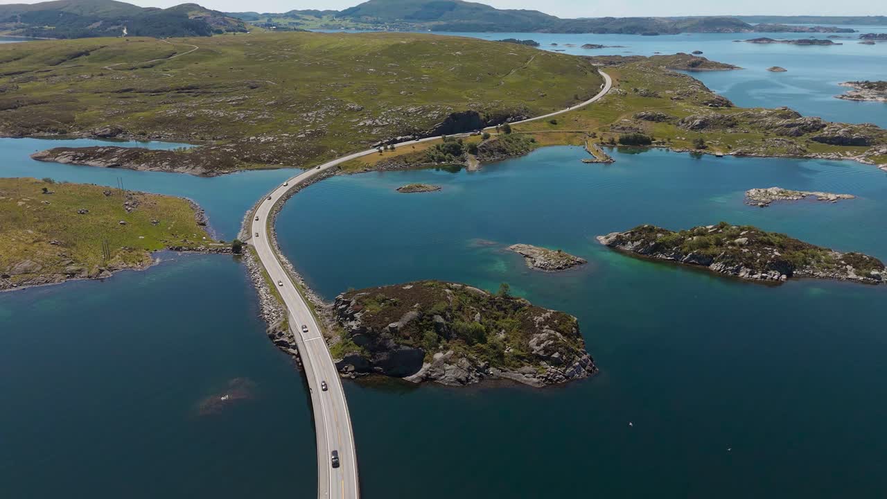 Atlantic Ocean Road, Norway. Fjord with clear blue and turquoise sea water at Kristiansund. Cars and bridge.