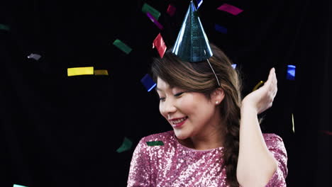 woman wearing a party hat with confetti