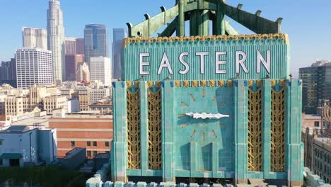 aerial of the historic eastern building in downtown los angeles with clock and downtown city skyline behind 2