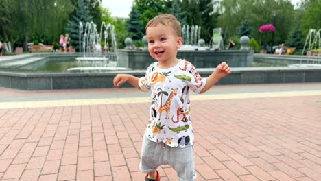 adorable happy toddler learning to hop. joyful baby boy trying to jump in the park.