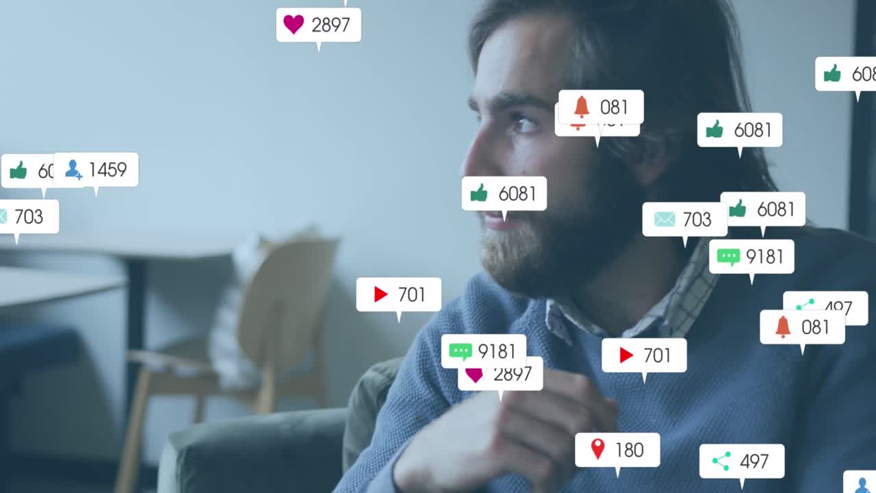 Animation of social media icons against thoughtful caucasian man sitting at office