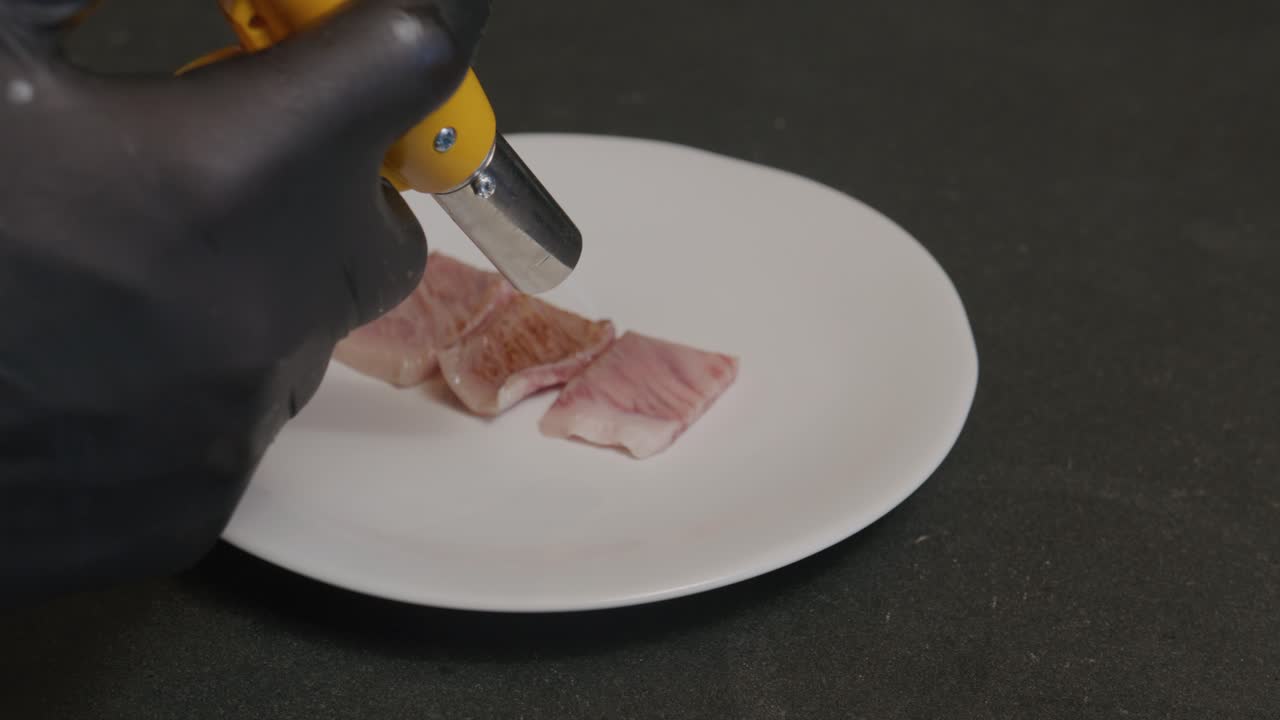 A5 Japanese Wagyu beef sizzles as it's expertly seared with a torch, enhancing its flavors