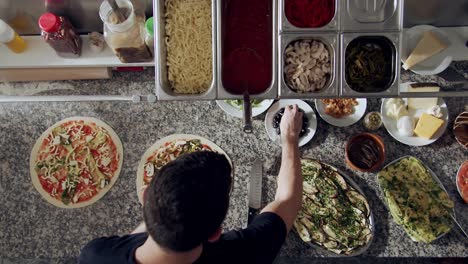 preparing vegetarian pizza in restaurant kitchen