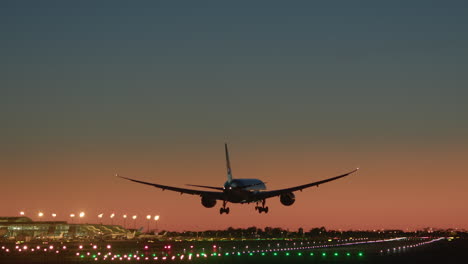 airplane landing at sunset