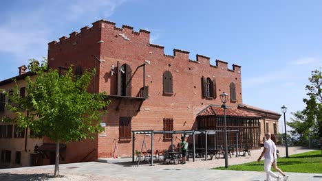 a man walks past a brick building