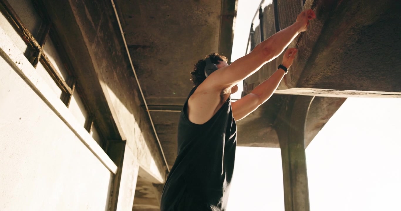 Young Man Exercising and Stretching in Urban Concrete Setting