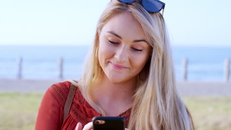 woman, face or laughing at phone by beach