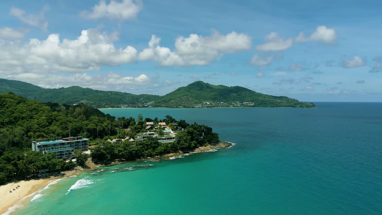 4K Cinematic nature aerial footage of a drone flying over the beautiful beach of Surin in Phuket, Thailand on a sunny day