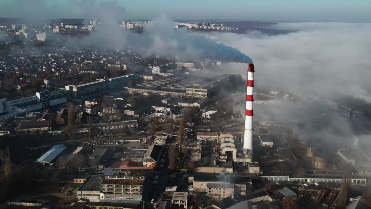 Aerial drone view of industrial smoke coming from pipe factory tube. City pollution idea