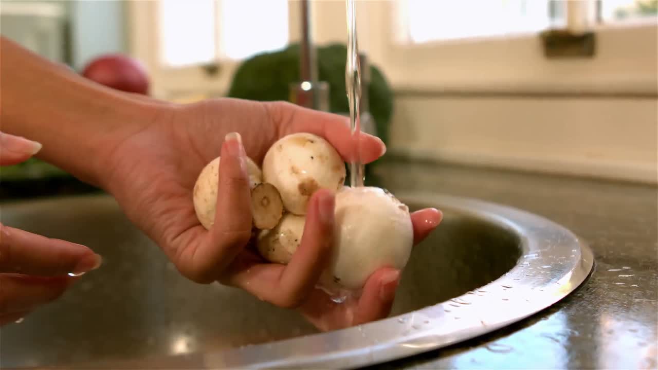 Woman washing mushrooms