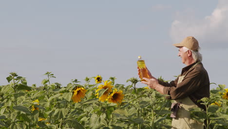 man with bottle of sunflower seed oil