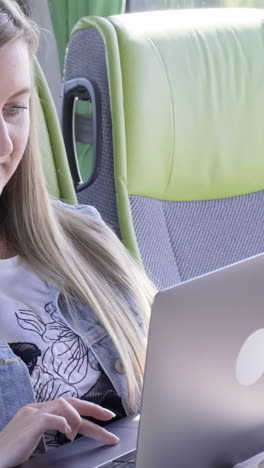 woman using laptop on a bus