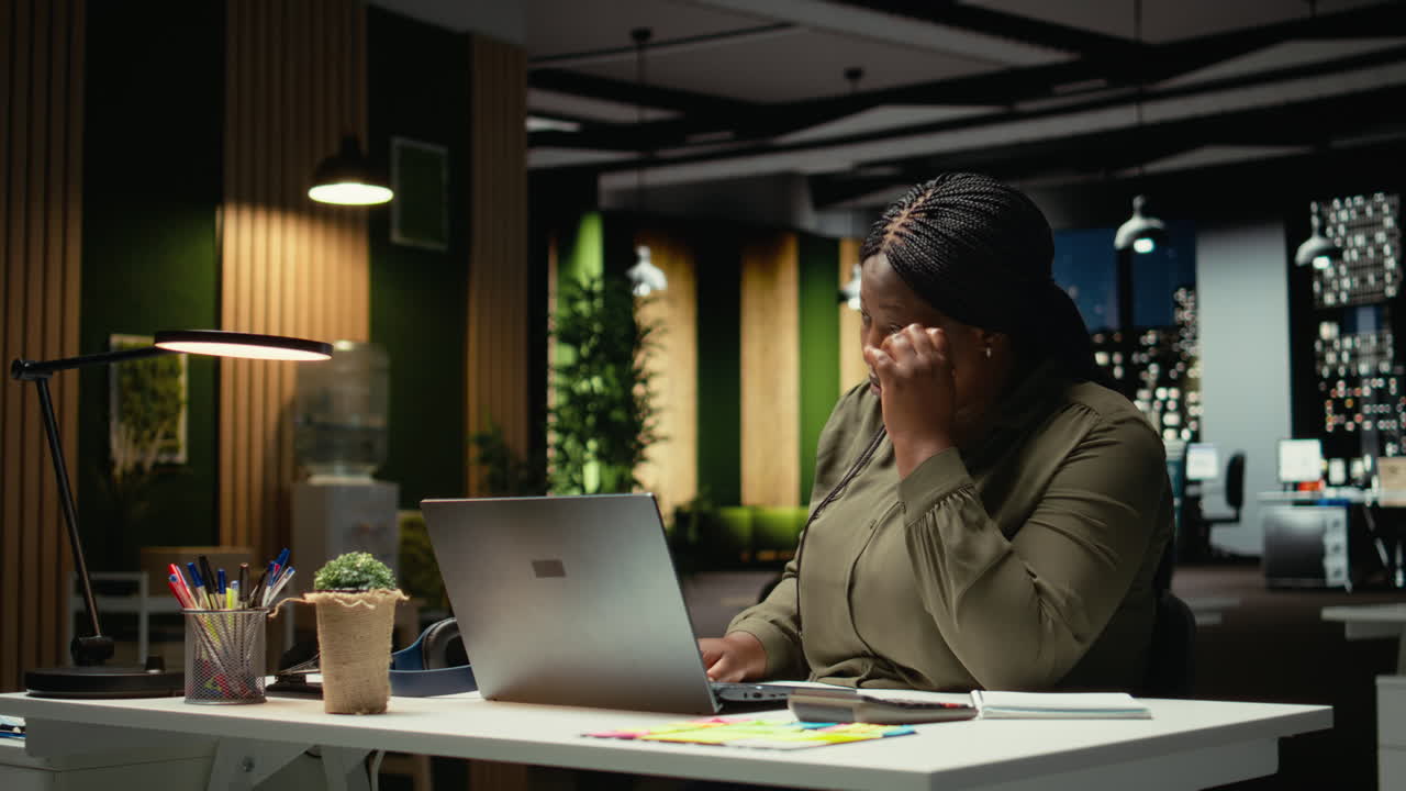 Demotivated businesswoman sighing after realizing the late hour